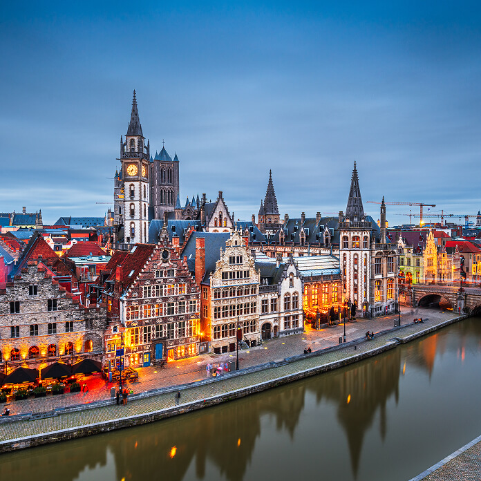 Ghent, Belgium old town cityscape from the Graslei area at dusk.