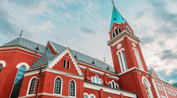 Saint Anthony Church's towering belfry, reaching towards the heavens amidst Sarajevo's skyline.
