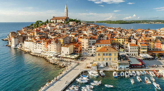 Aerial view of the Rovinj old town at sunset, famous ancient Croatian city at the Adriatic sea, Istria peninsula, Croatia. Rovinj cityscape, cathedral of St. Euphemia and historic buildings