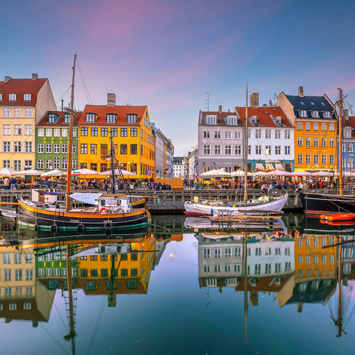 Cityscape of downtown Copenhagen city skyline in Denmark at famous old Nyhavn port at sunset