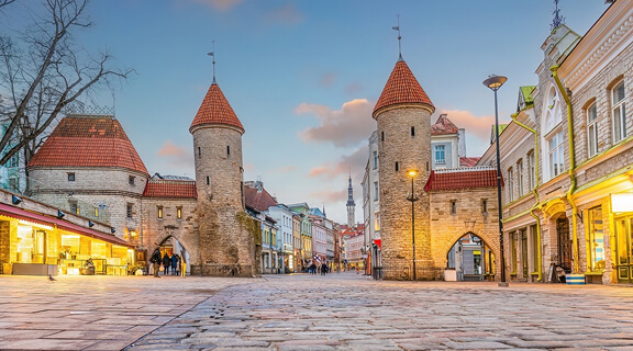 Twin towers of Viru Gate in Old town Tallinn, cityscape of Estonia at sunset