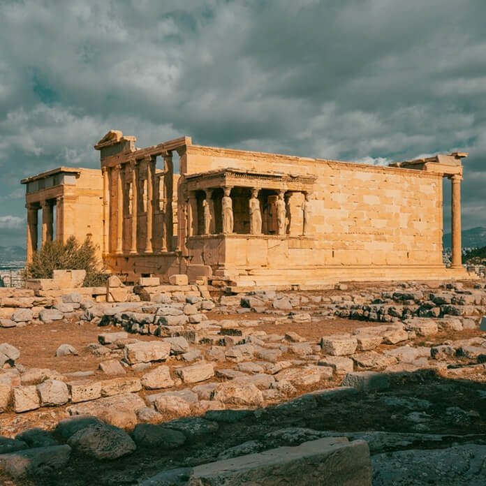 Ancient Erechtheion Greek temple with Porch of the Caryatids on the north side of the Acropolis in Athens, Greece. It was dedicated to both Athena and Poseidon. Caryatids at Porch of the Erechtheion.