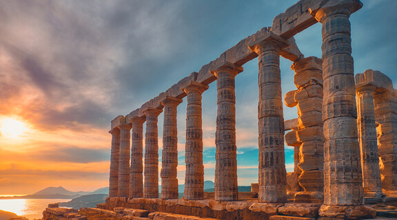 Greece Cape Sounio. Ruins of an ancient temple of Poseidon, Greek god of the sea, on sunset. Shot of temple ruins on sunset. Tourist landmark of Attica, Sounion, Greece