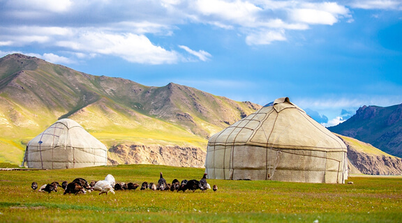 Yurt. National old house of the peoples of Kyrgyzstan and Asian countries. national housing. Yurts on the background of green meadows and highlands. Yurt camp for tourists.