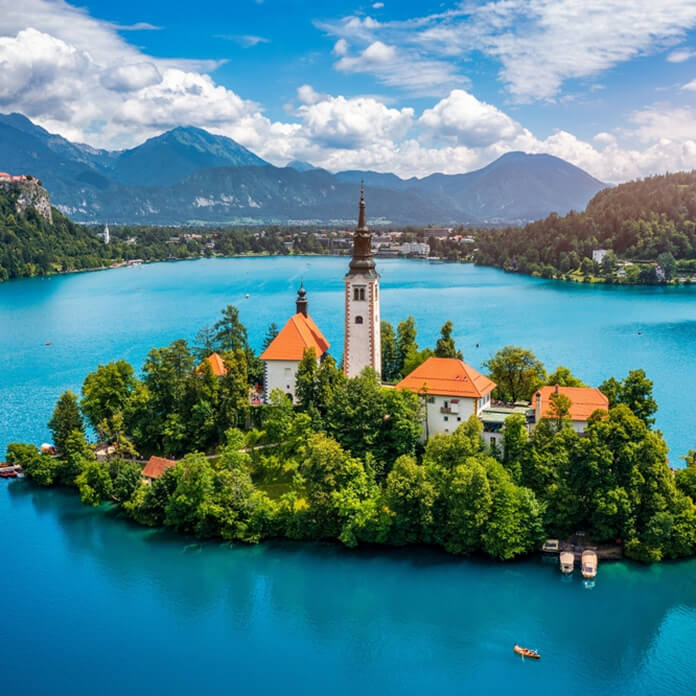 Lake Bled in Slovenia. Beautiful mountains and Bled lake with small Pilgrimage Church. Bled lake and island with Pilgrimage Church of the Assumption of Maria. Bled, Slovenia, Europe.