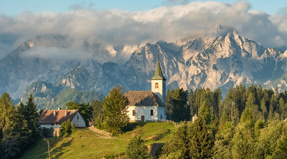 Beautiful Slovenian Alpine landscape featuring the small Sveti Duh or St. Spirit church in the Kamnik-Savinja Alps during the summer in Slovenia.