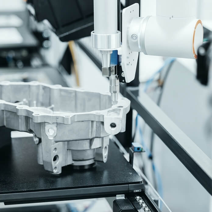 Precision cnc coordinate measuring machine analyzing engine part in high-tech manufacturing conveyor.